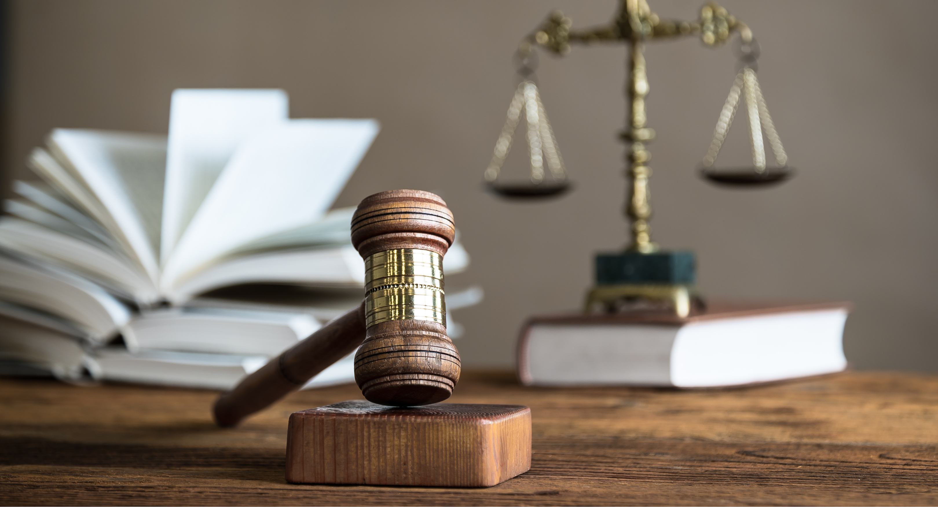 judge's gavel with legal scales and law book