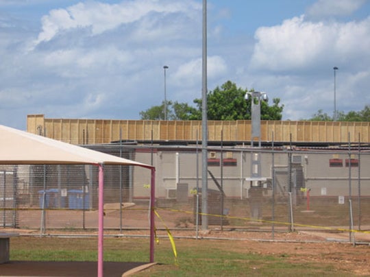 Description: Electrified fence separating North and South compounds, NIDC 