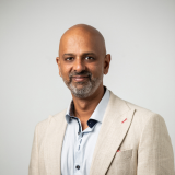 Bald man with beard wearing cream blazer