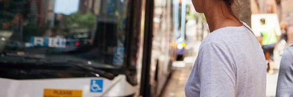 A lady walking to the bus