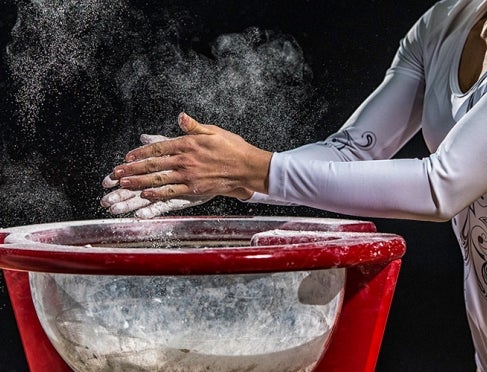 Gymnast applying chalk