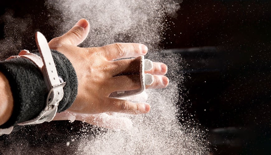 Gymnast applying chalk