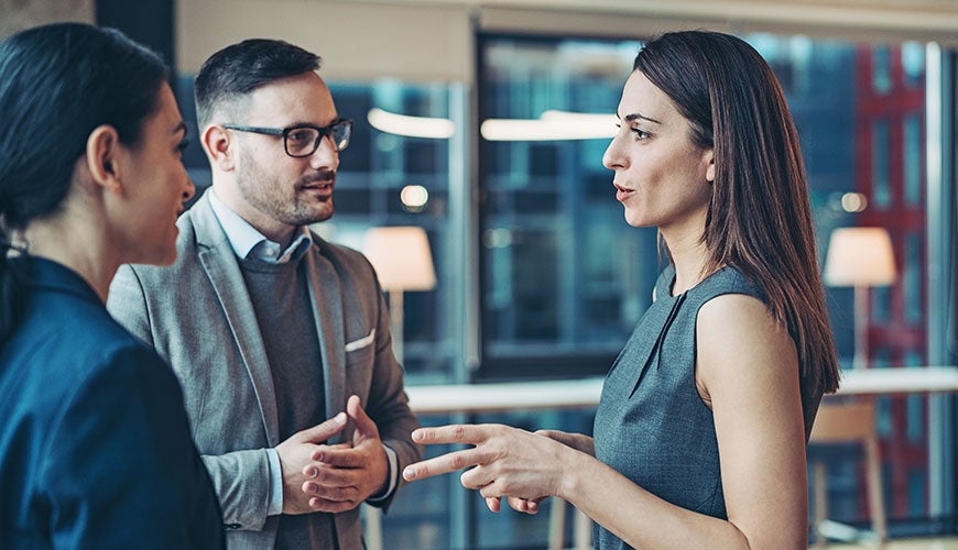 business women and man talking in office