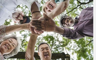 Diverse group of older people smiling in a circle 