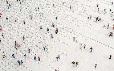 crowd walking over binary code