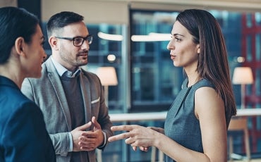 business women and man talking in office