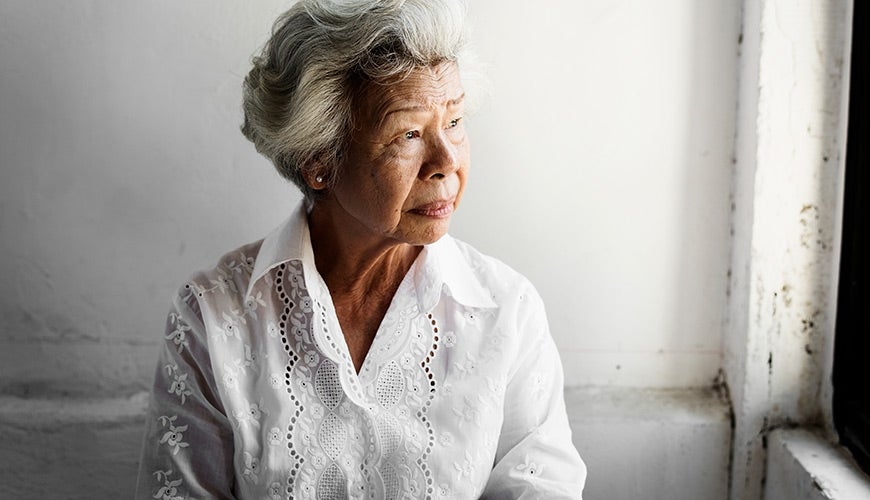 Elderly lady looking out a window