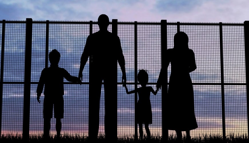 Silhouette of a refugees family with children