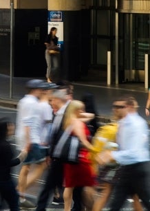 Bustling city street with people crossing the road