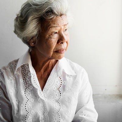 Elderly lady looking out a window