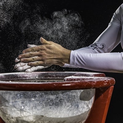 Gymnast applying chalk