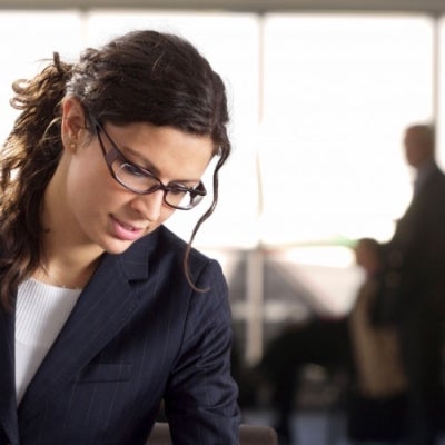 Woman looking down at her work in office setting