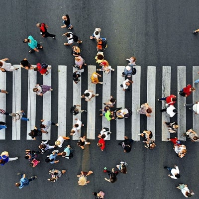 Street crossing scene from above, several dozen people crossing