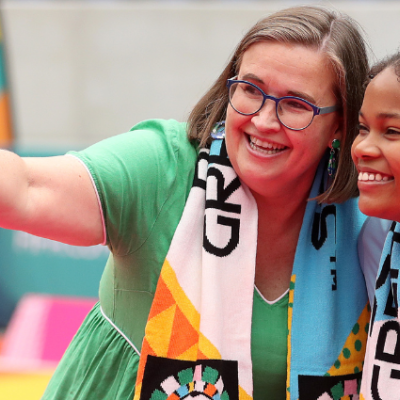 A woman, Sex Discrimination Commissioner Kate, takes a selfie with a young person and smiles.