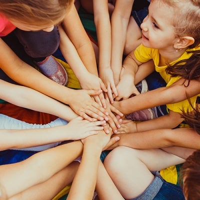 Children in a group holding hands