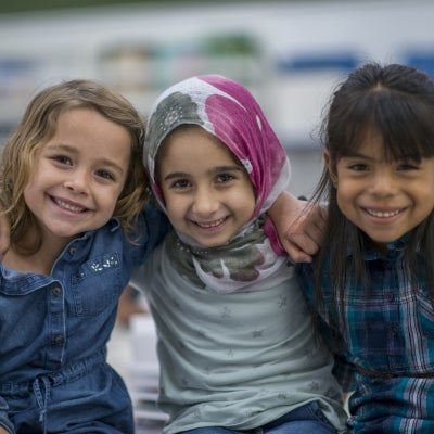 Diverse trio of girls smiling and happy