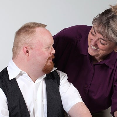 Worker with Down Syndrome and co-worker. Image from iStock.