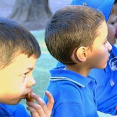 Young children eating lunch in their uniform