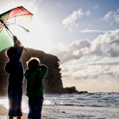 Photo: Children on a beach with an umbrella